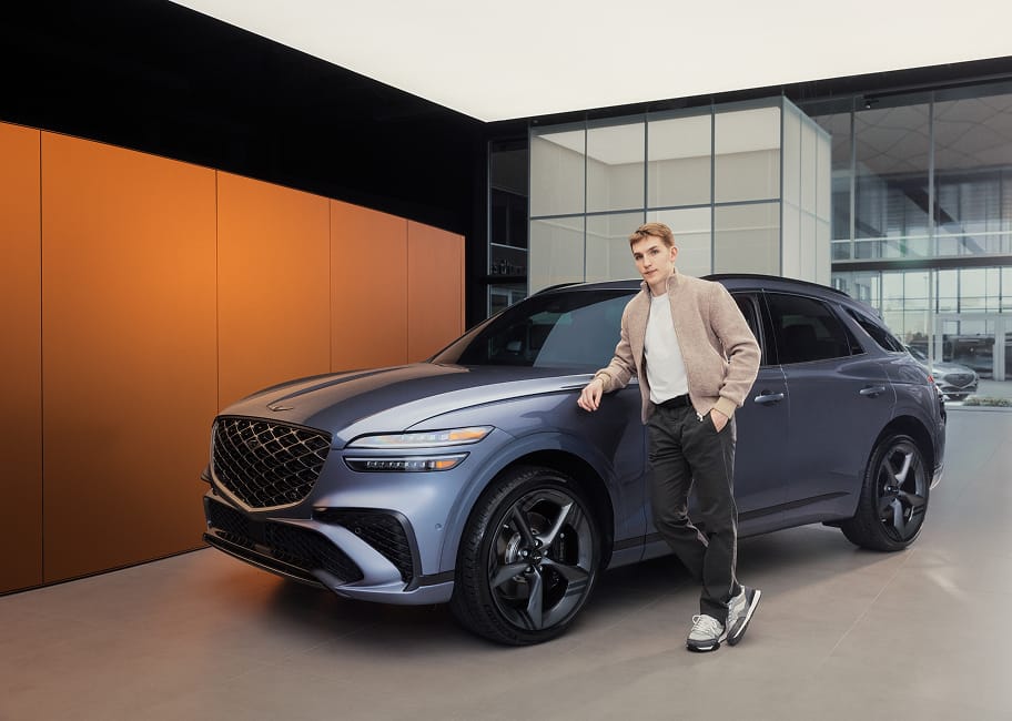 Lane Hutson leaning against a Genesis GV70