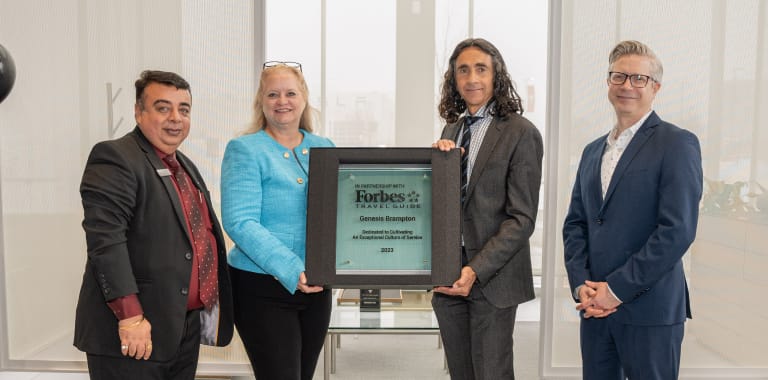 L'équipe de Genesis Brampton avec la plaque du Forbes Travel Guide