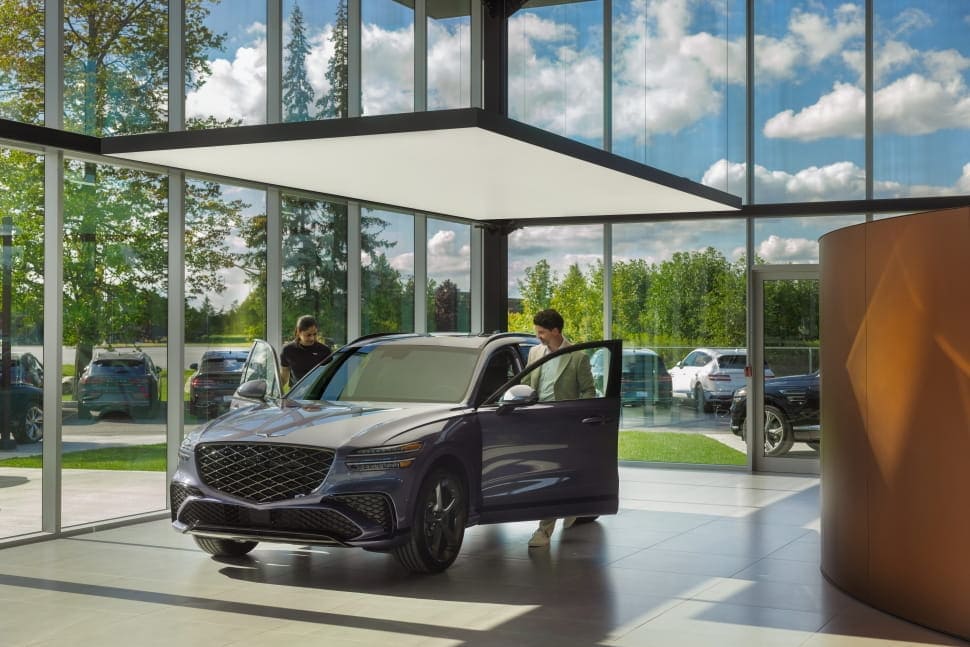 Man steps into Genesis GV70 at Genesis distributor