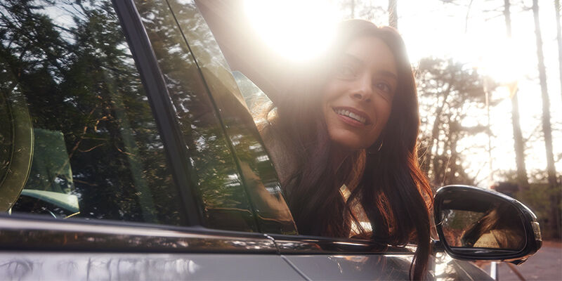 Woman looking out of the passenger window in a Genesis G70