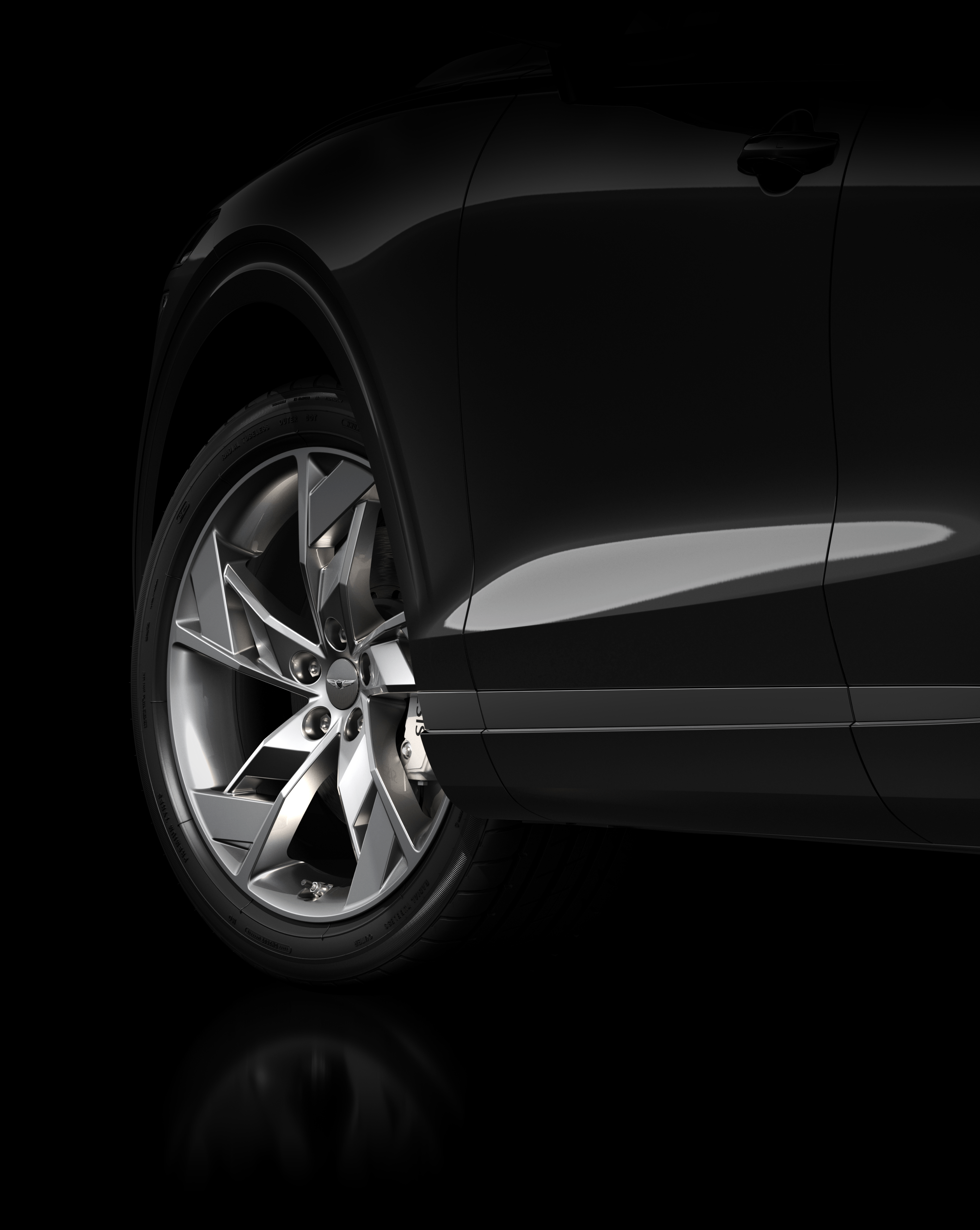 The Electrified GV70’s tire turns to the left on a black tarmacked road.