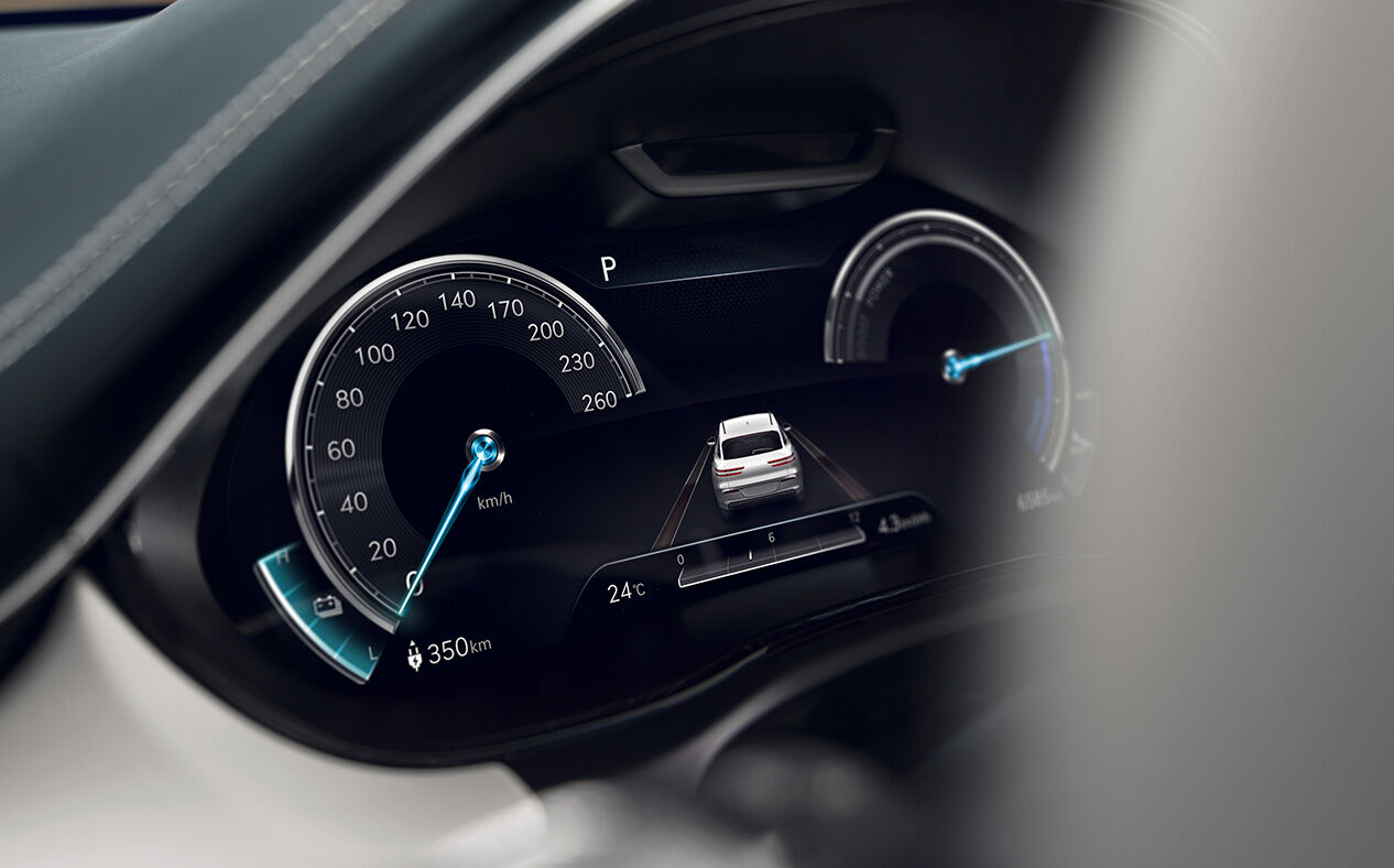 The 12.3-Inch Cluster is seen close up from inside the car with its light on.