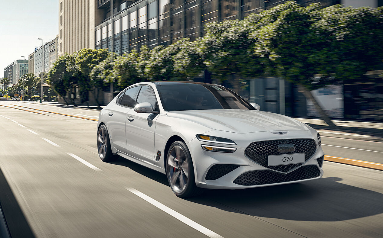 White G70 driving on a city street