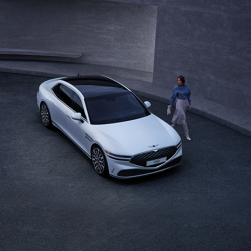 Woman standing beside white G90