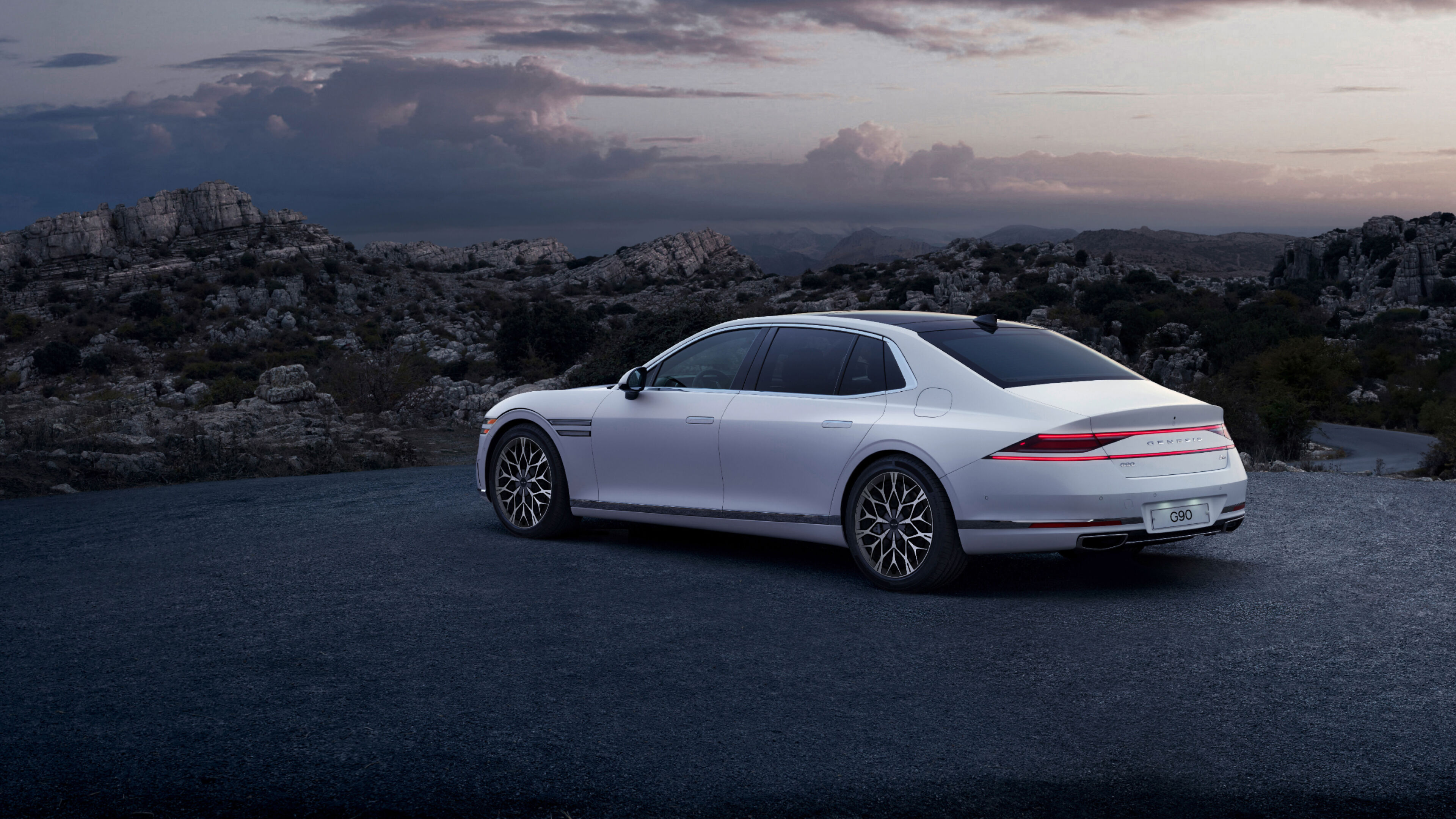 Rear end of Verbier White G90 seen overlooking a cliff.