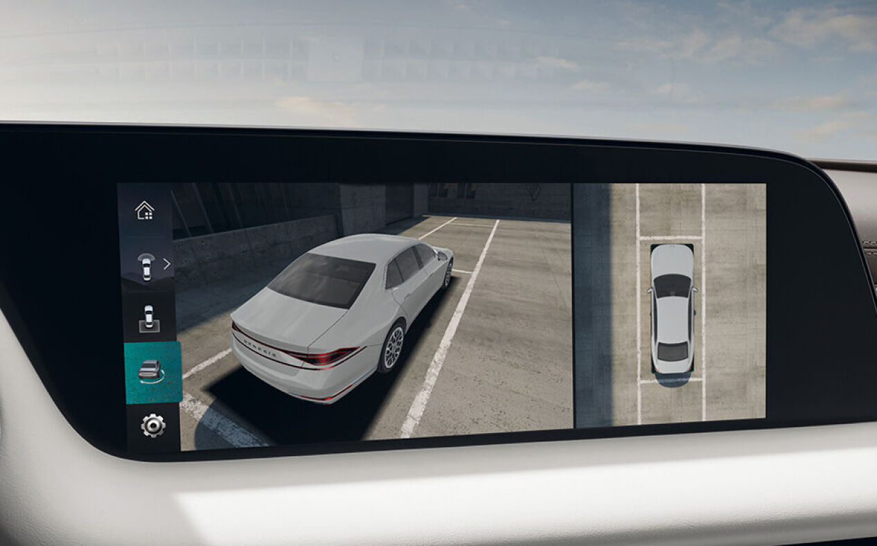 The area surrounding the vehicle is seen through the surround view monitor on the infotainment display in Glacier White interior.
