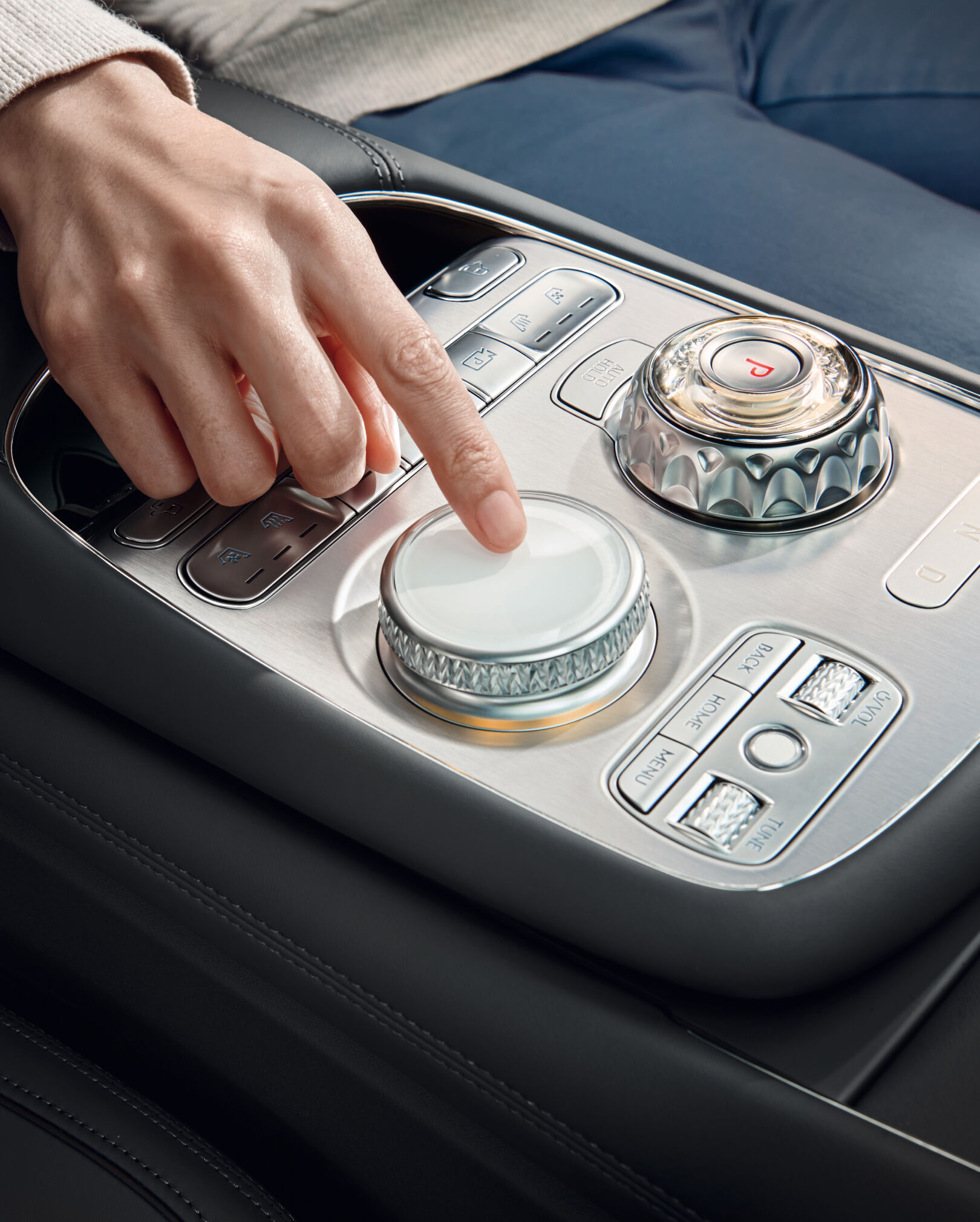 A hand operates the controller.