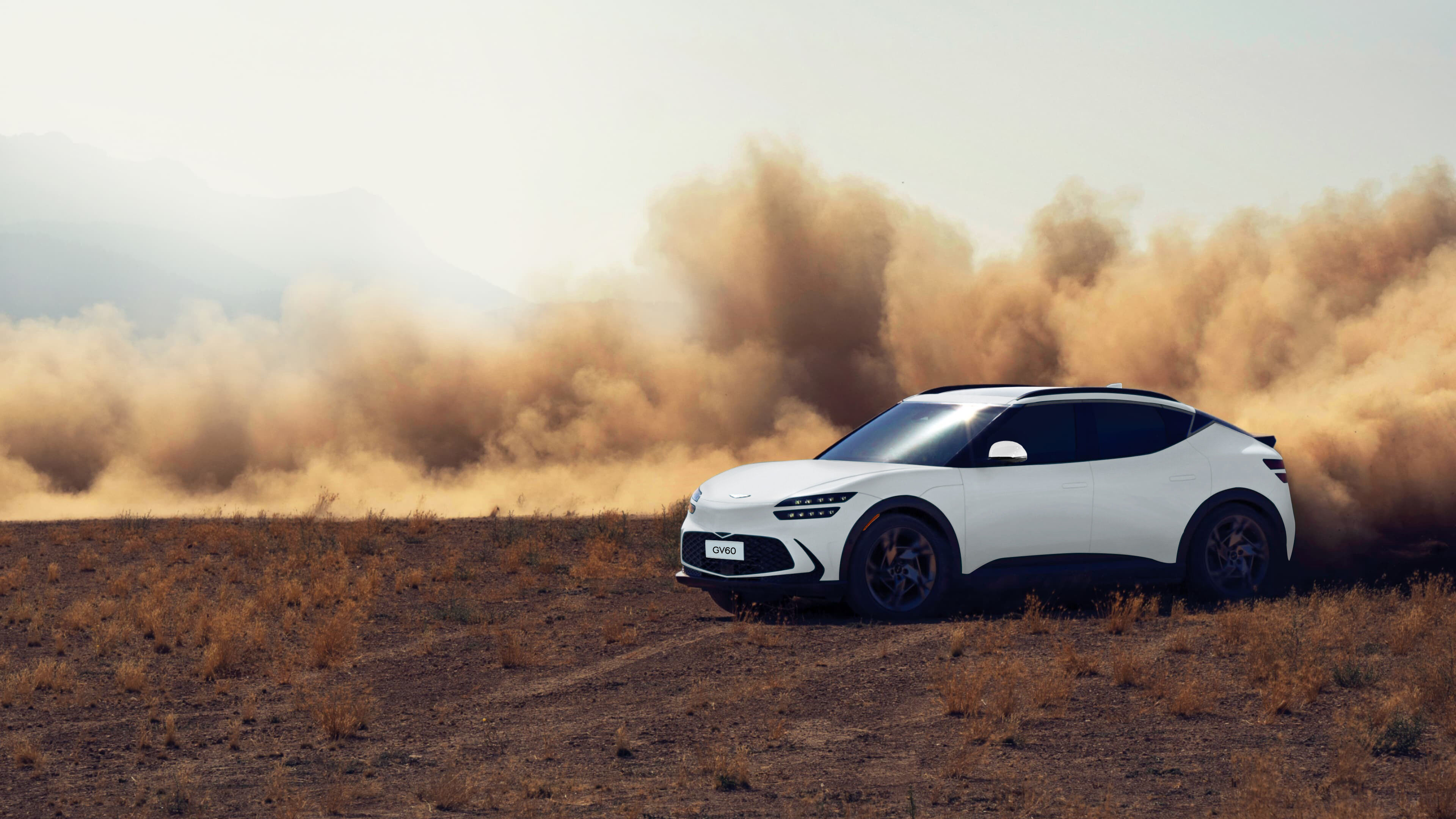 Uyuni White GV60 is seen driving on a sandy beach.