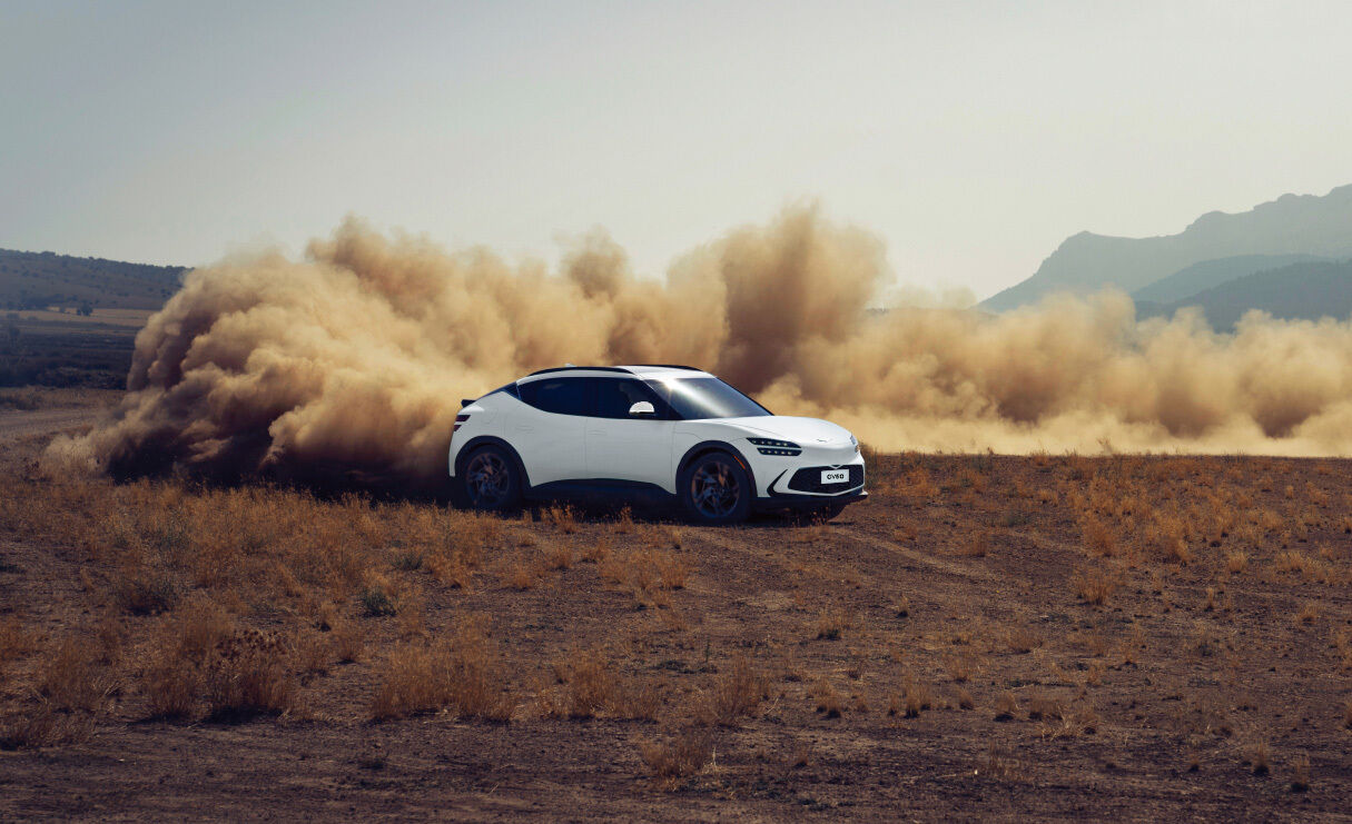 GV60 driving on a sandy beach.