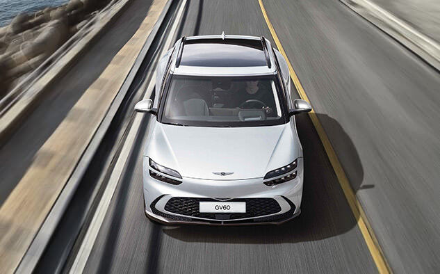 You can see the front of the GV60 driving on the highway.
