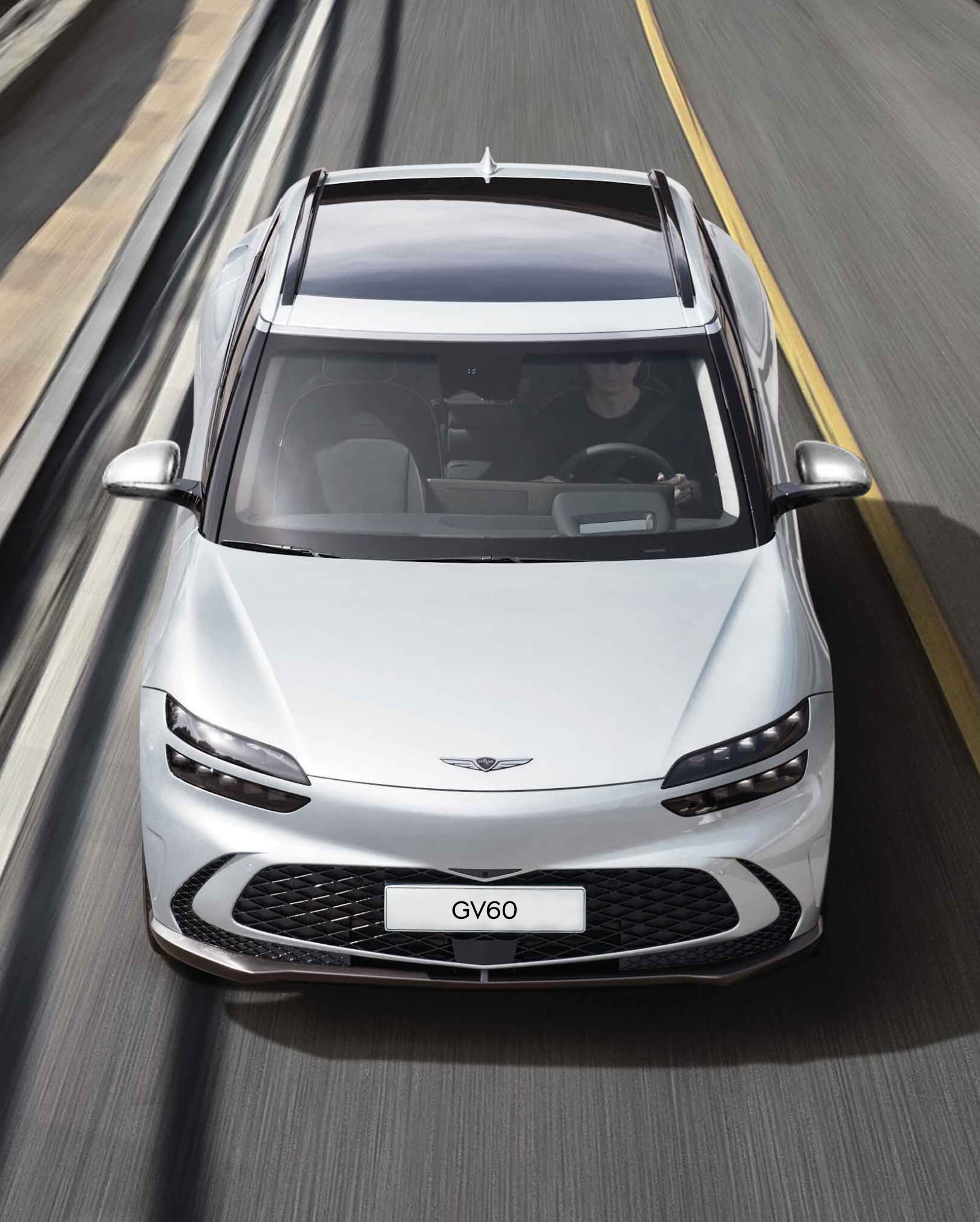 GV60 driving on the highway while maintaining its lane.