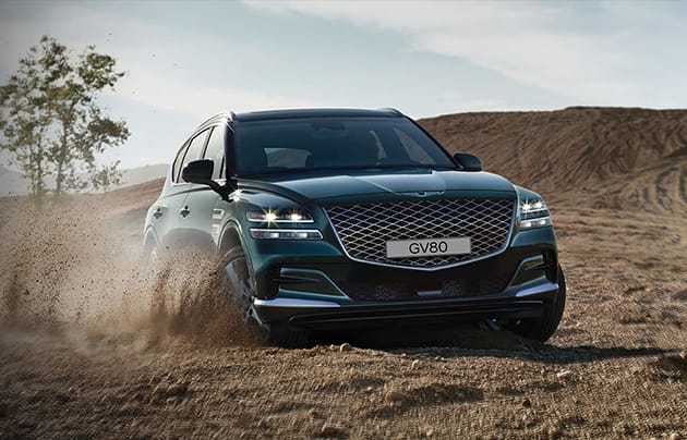 Genesis GV80 driving through the dirt