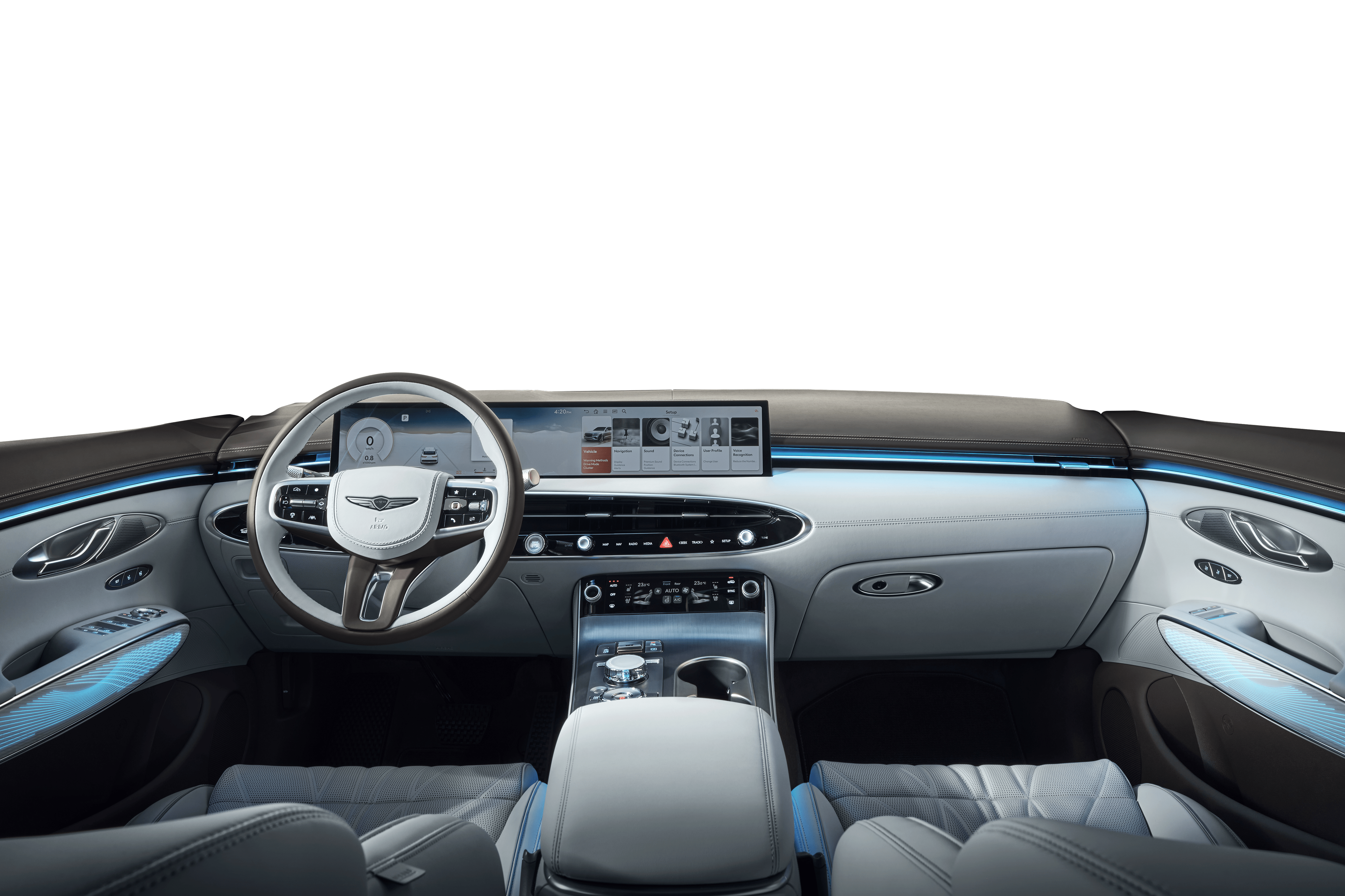 You can see the interior of the front seats of the GV70. A wide display is illuminated in the center of the front of the vehicle, while the blue interior lights softly illuminate the cabin.