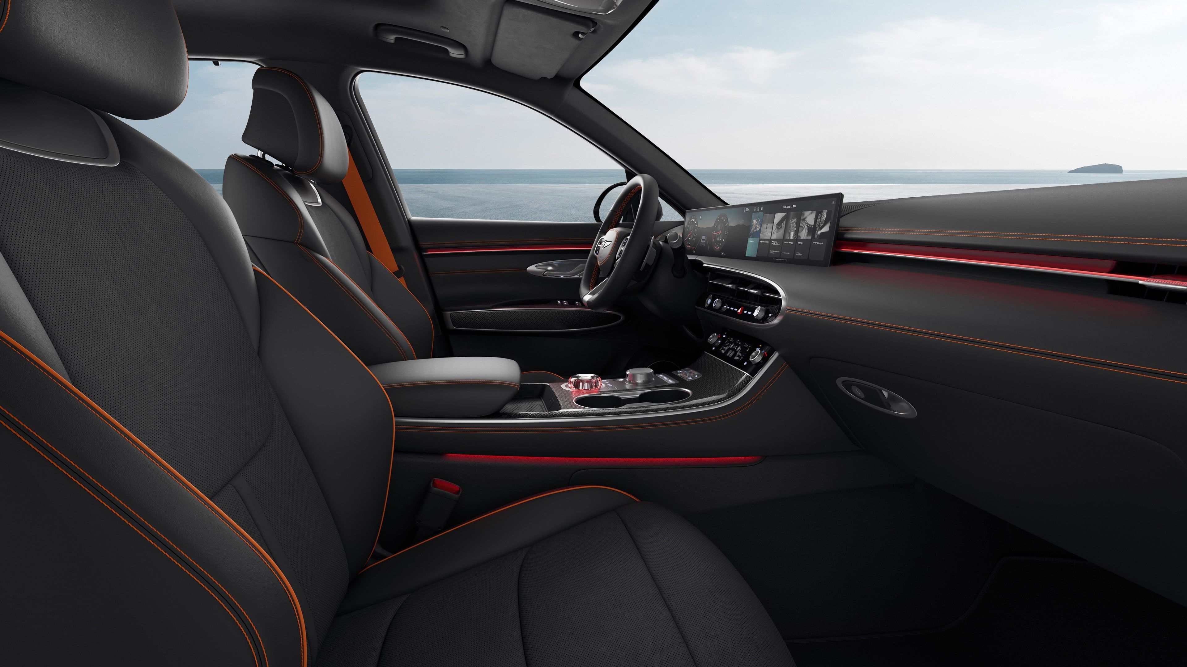 You can see the driver's seat of the GV70 Sports Package with a monotone colour of Obsidian Black. The view is from the passenger seat, and there's a subtle red mood lighting.