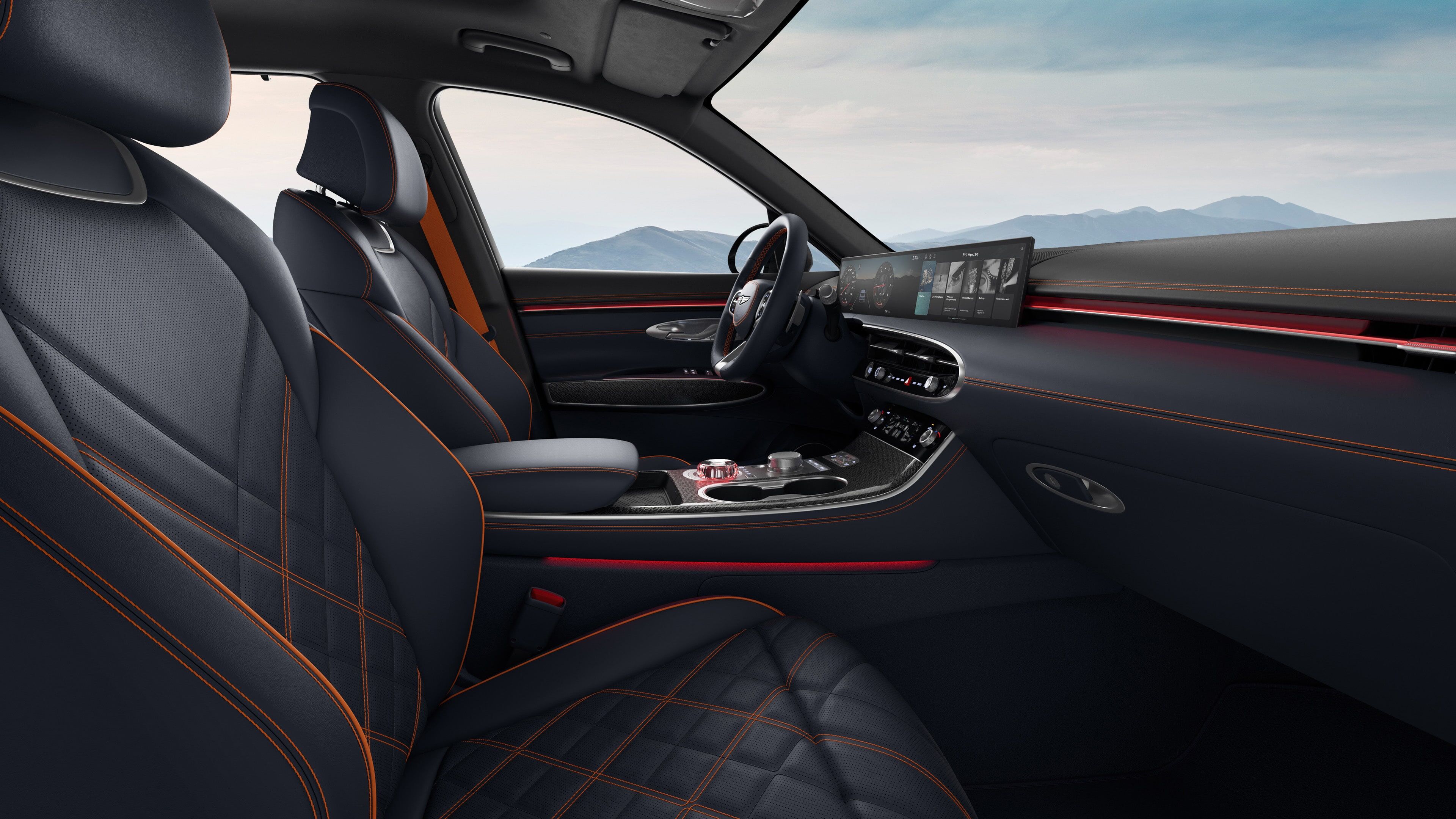 You can see the driver's seat of the GV70 Sports Package with a two-tone colour combination of Ultra Marine Blue. The view is from the passenger seat, and there's a subtle red mood lighting.   