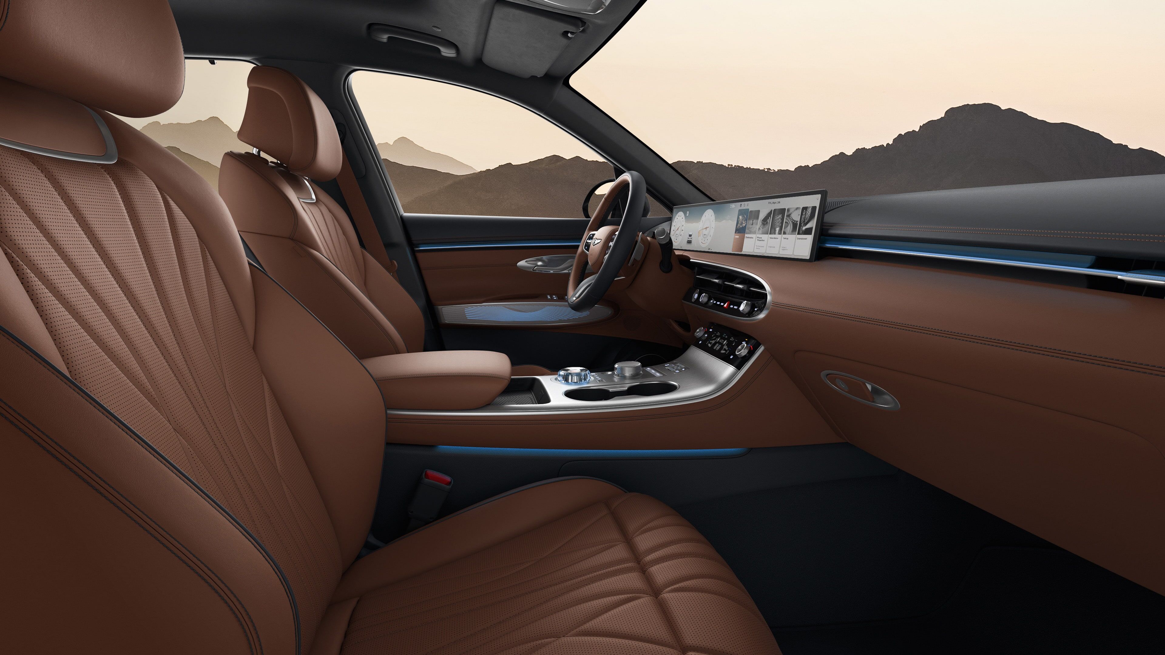 You can see the driver's seat of the GV70 with a two-tone colour combination of Ocean Wave Blue and Havana Brown. The view is from the passenger seat, and there's a subtle blue mood lighting.