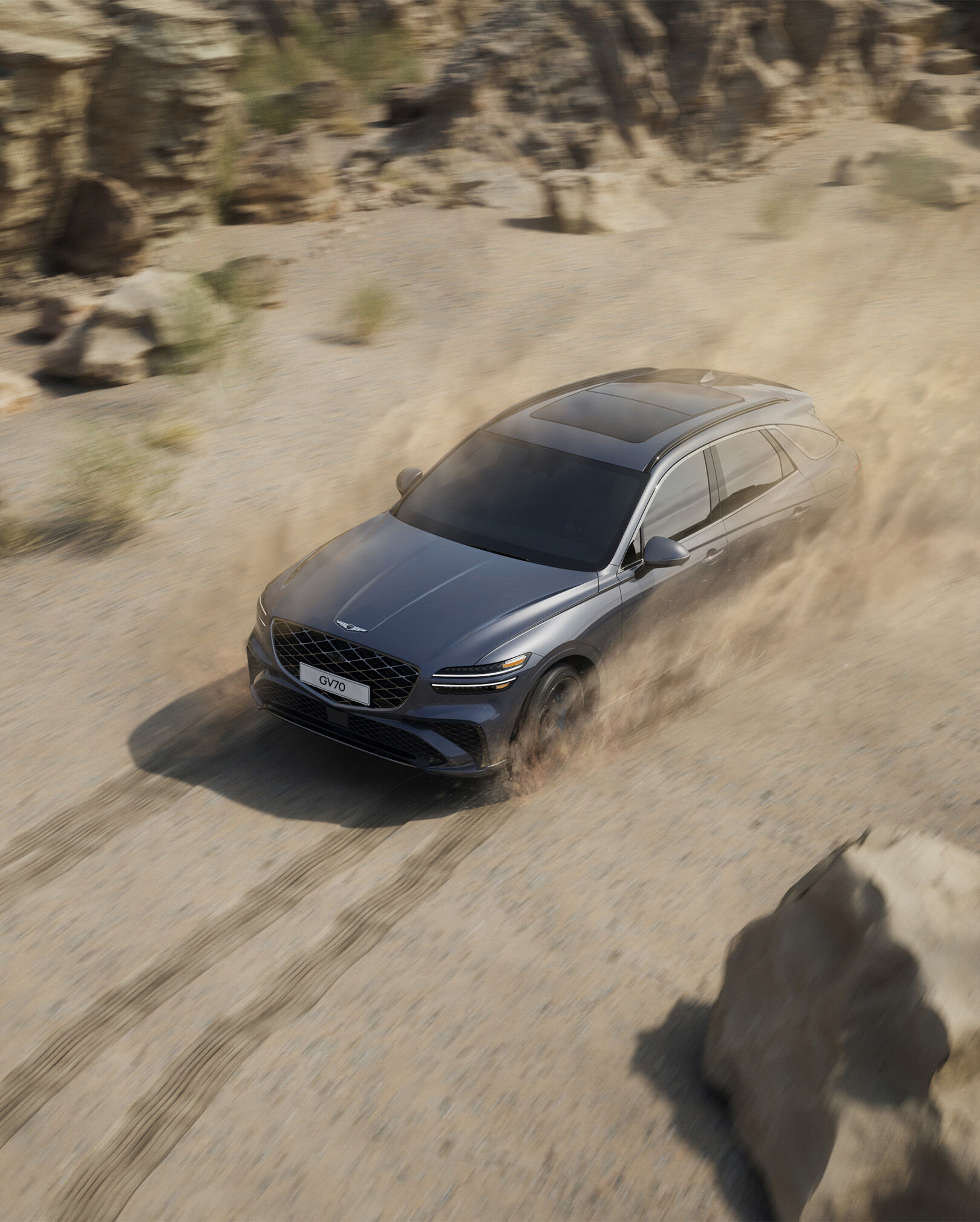 The GV70 is driving dynamically in the desert.