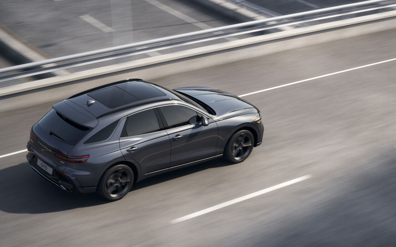 You can see the rear view of the GV70 driving while staying in its lane.