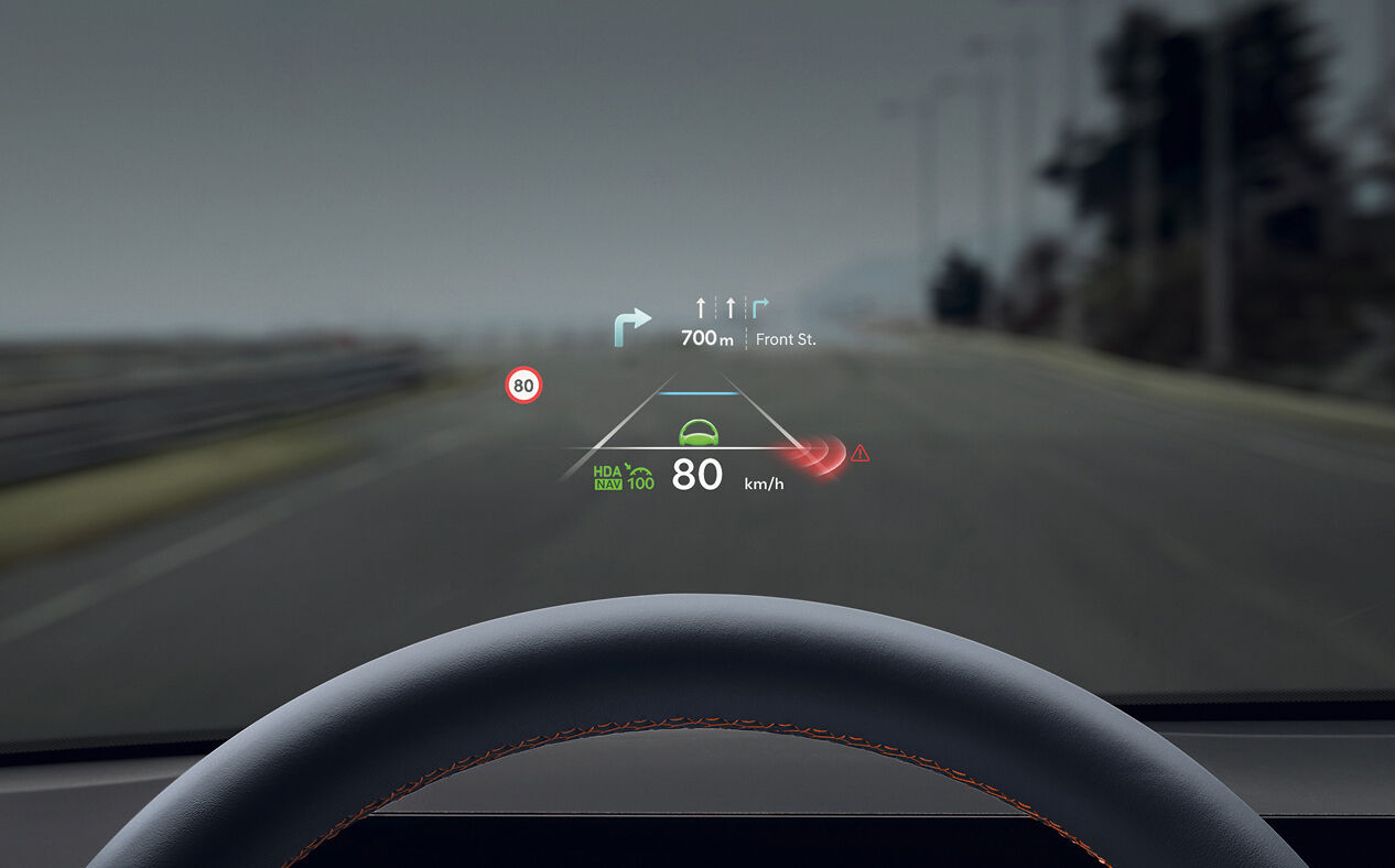 Advanced driver assistance systems are implemented on the windshield in front of the driver's seat. Driving information and sensor detections are displayed.