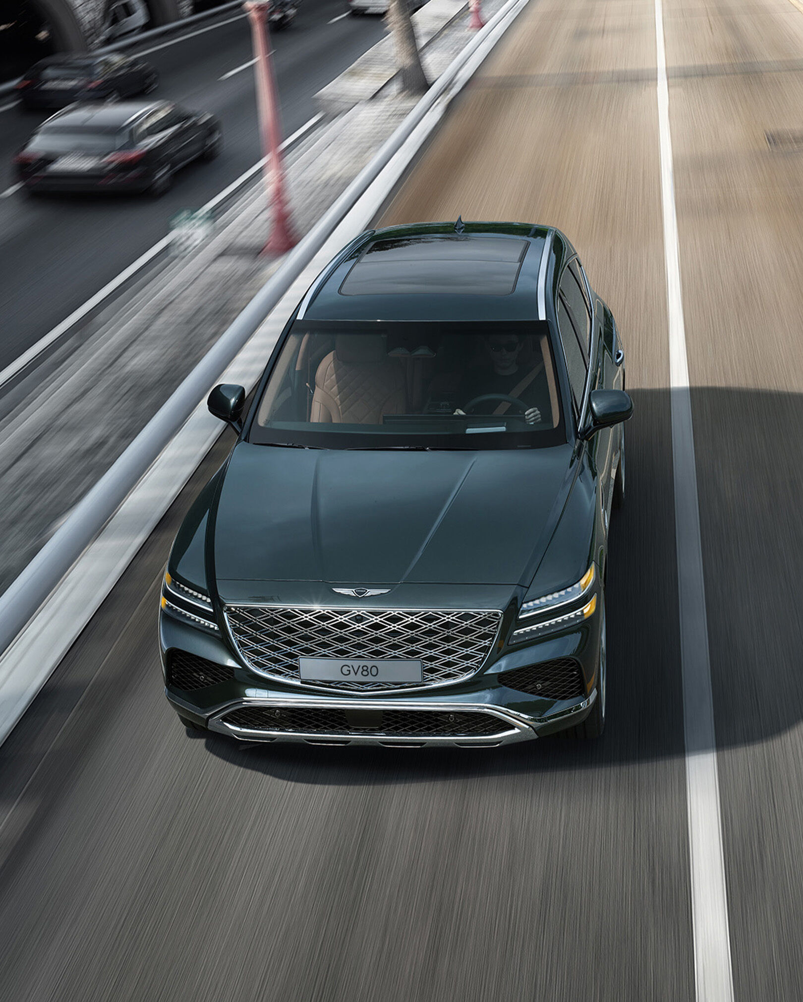  Storr Green GV80 driving on the highway.
