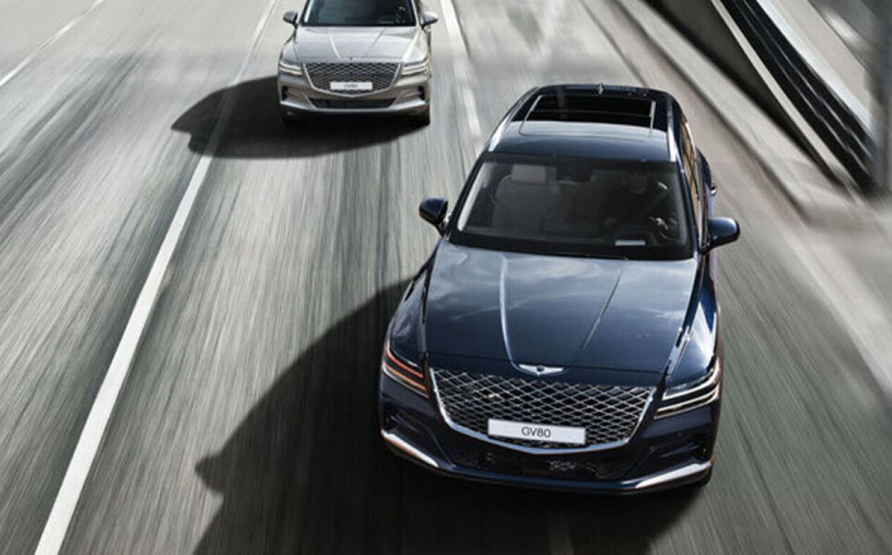 Blue GV80 passing vehicle on highway