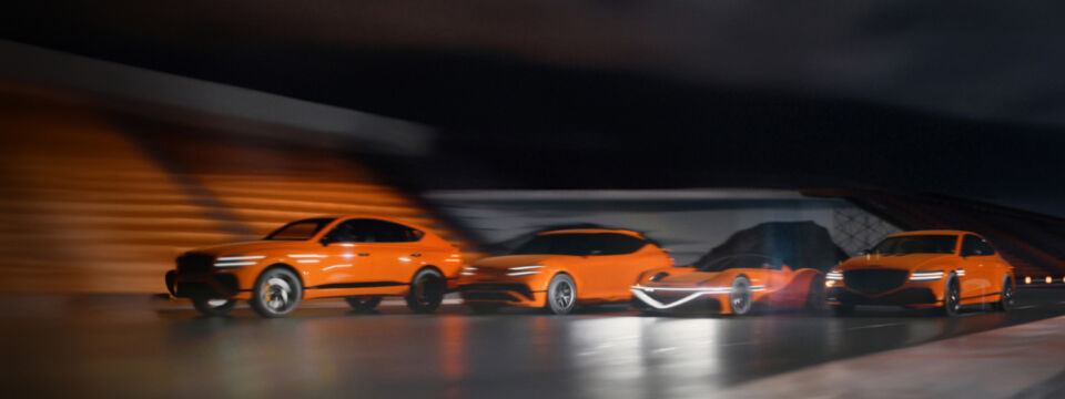 Four cars from the Genesis Magma lineup are lined up on the night racing track.