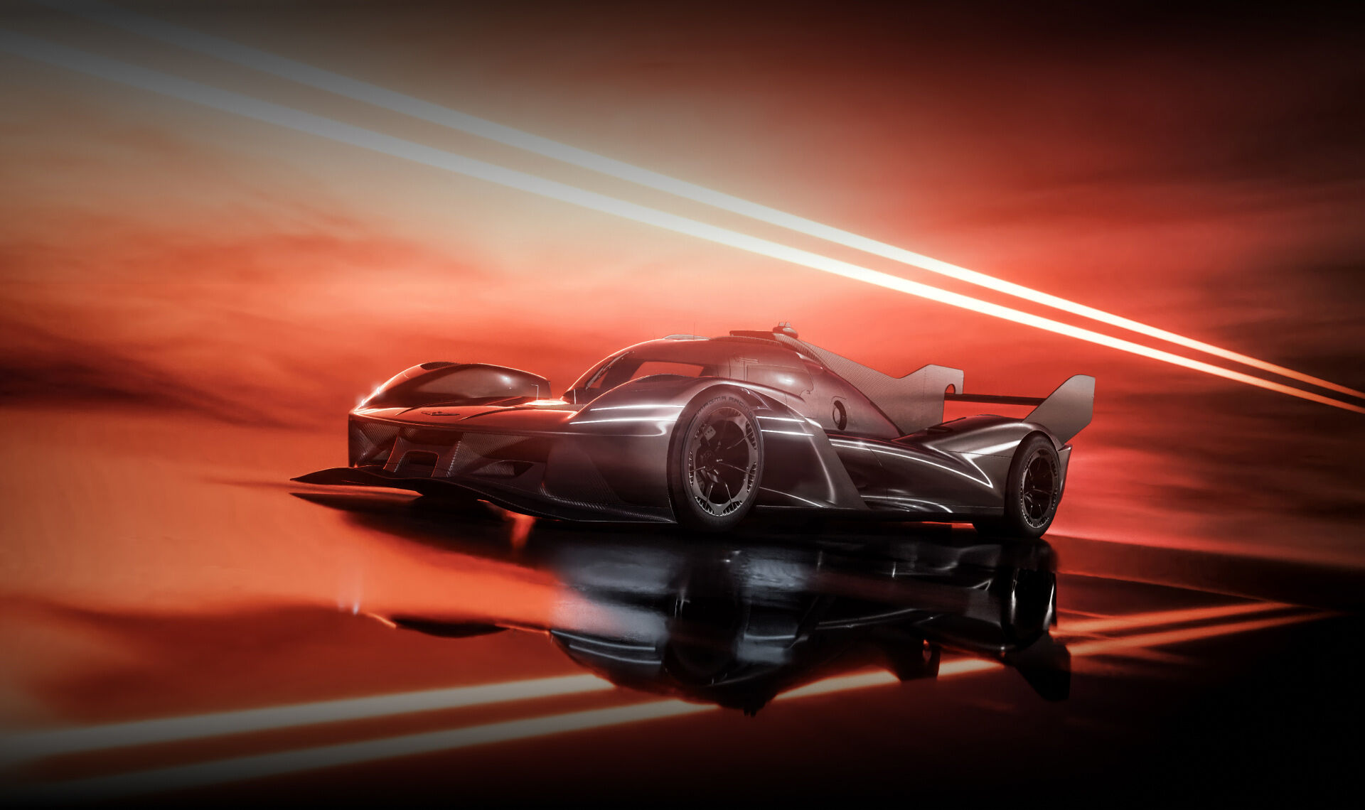 The magma-colored GMR-001 hypercar stands with its front end visible on the road against a black background.