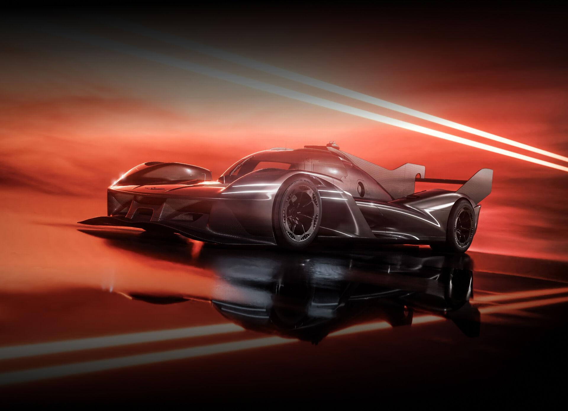 The magma-colored GMR-001 hypercar stands with its front end visible on the road against a black background.