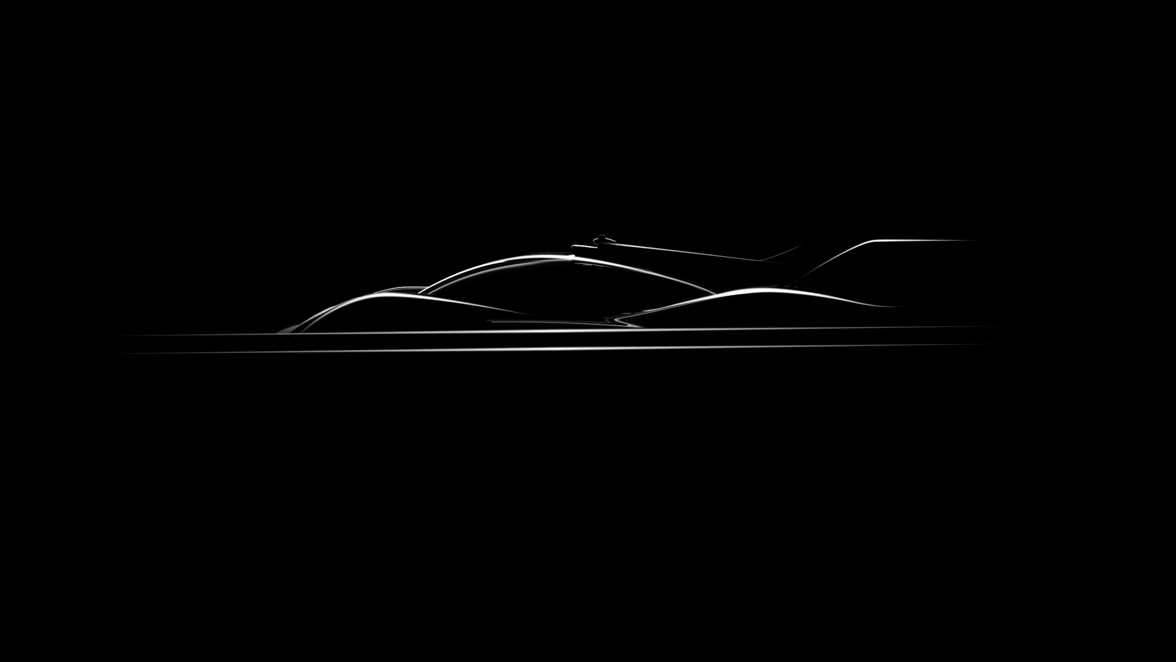 Against the black darkness, the silhouettes of the Genesis Magma lineup vehicles glow white.