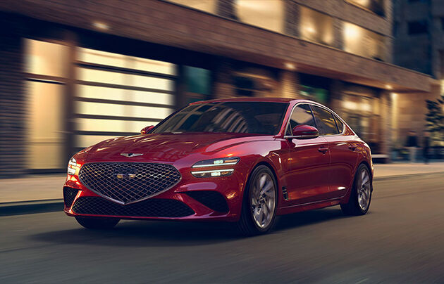Red Genesis G70 driving on the street 