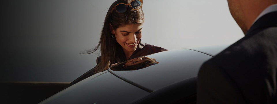 Woman beside Genesis vehicle