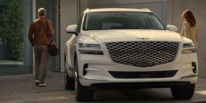 Genesis Owner beside their vehicle