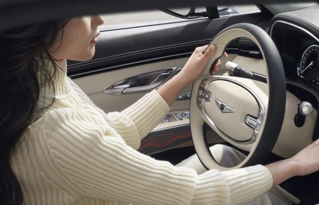 Woman driving a Genesis
