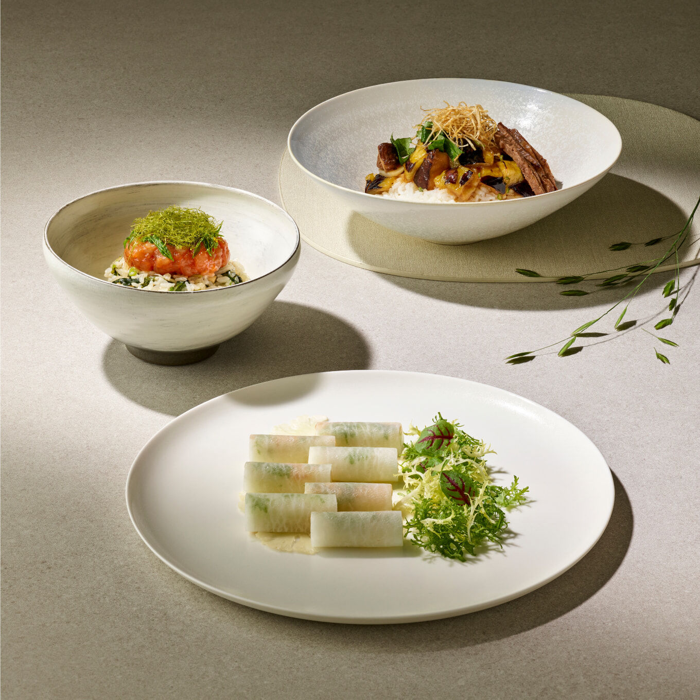 An a la carte menu of Korean food, neatly presented on white plates.