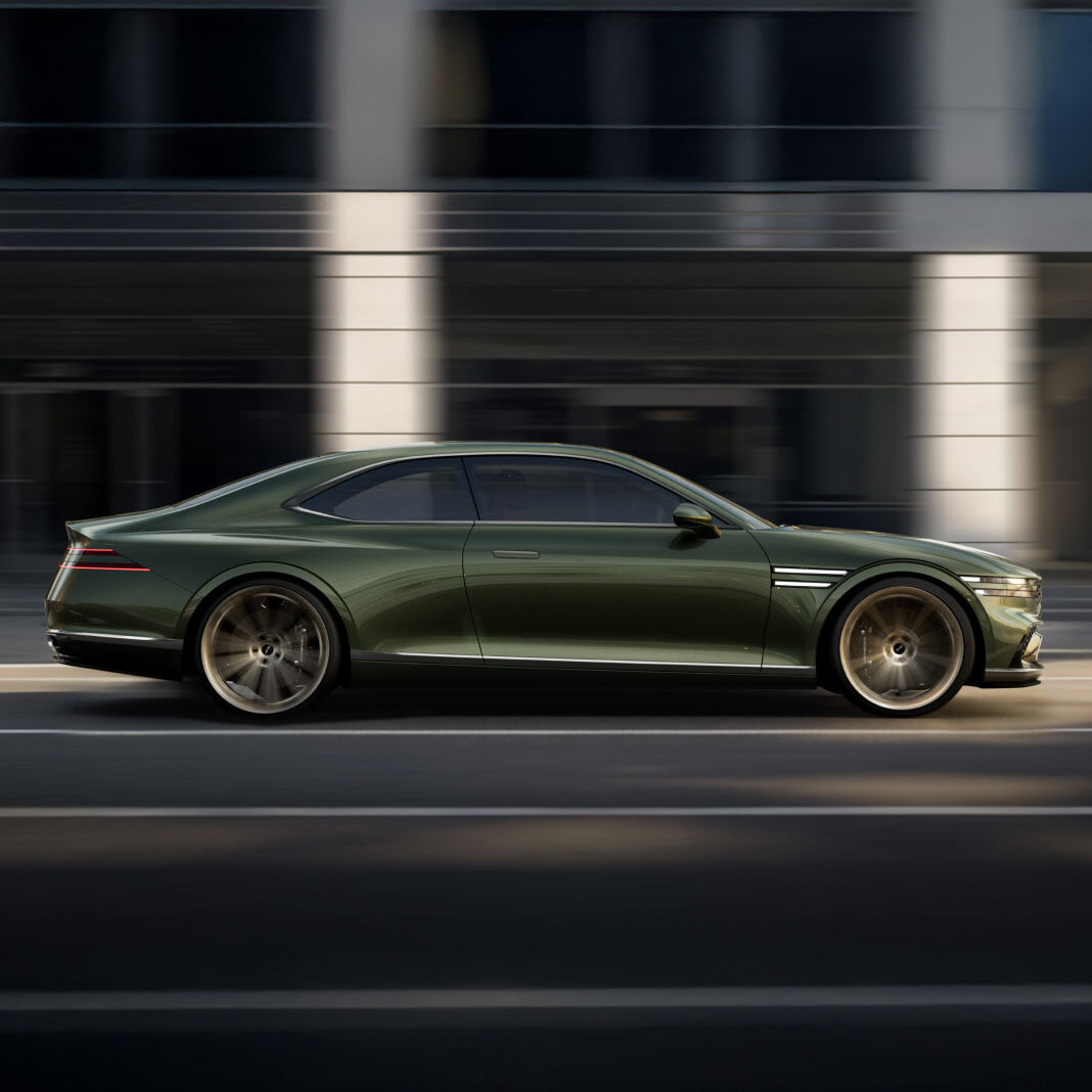 The Genesis X Gran Coupe is driving with its side visible.