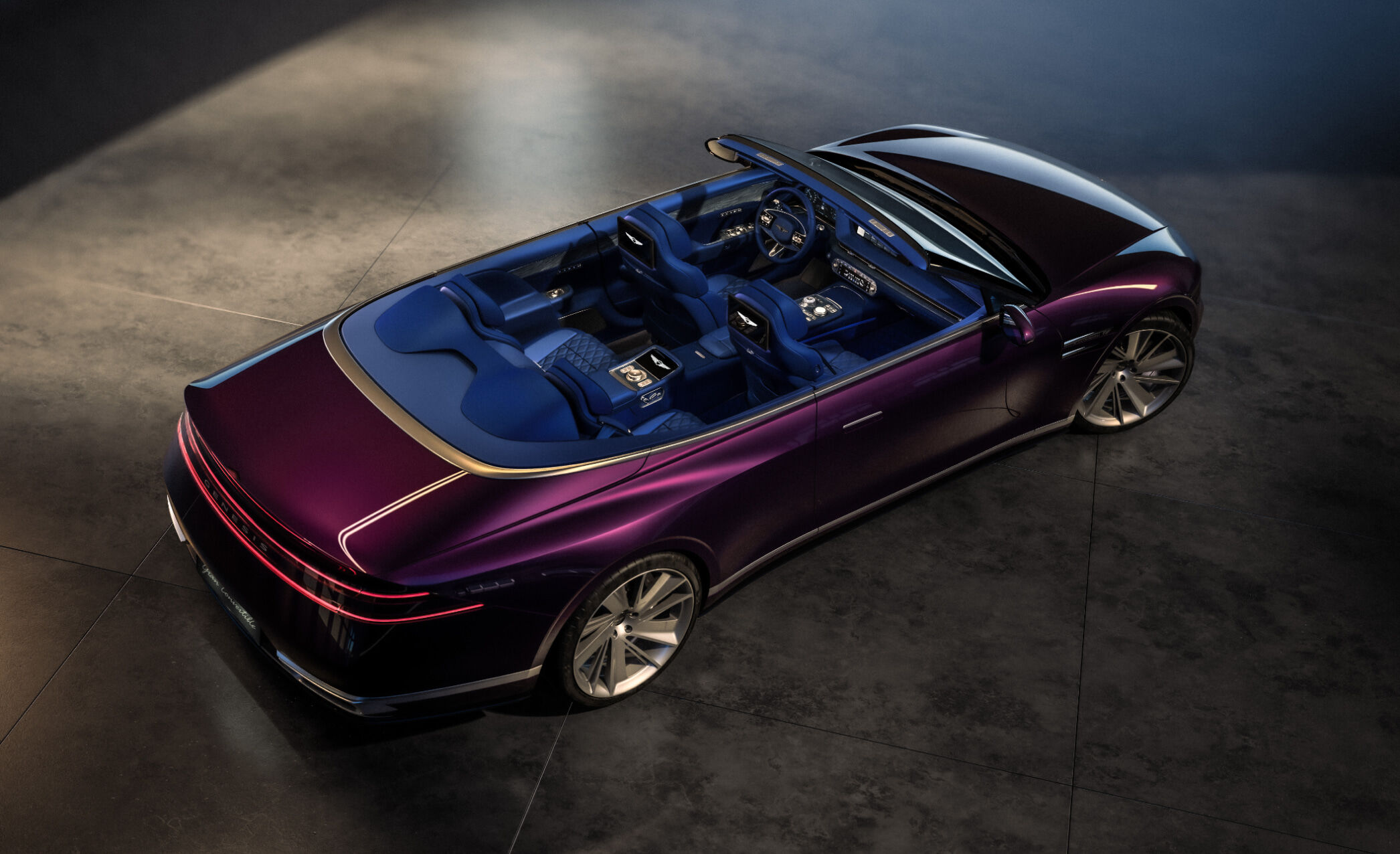 This is an aerial view of the Genesis X Gran Convertible. The interior of the vehicle is visible.