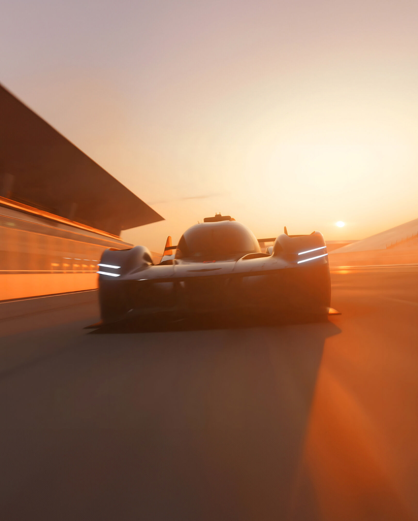 The GMR-001 Hypercar races through a racetrack during dawn, painting the overall backdrop orange.