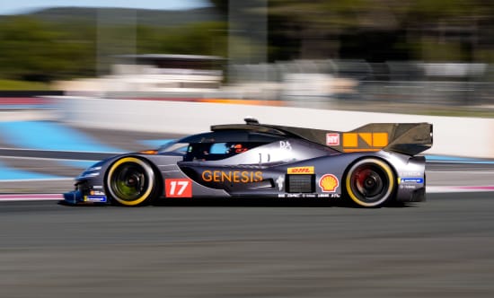 Side view of the GMR-001 hypercar racing on a circuit