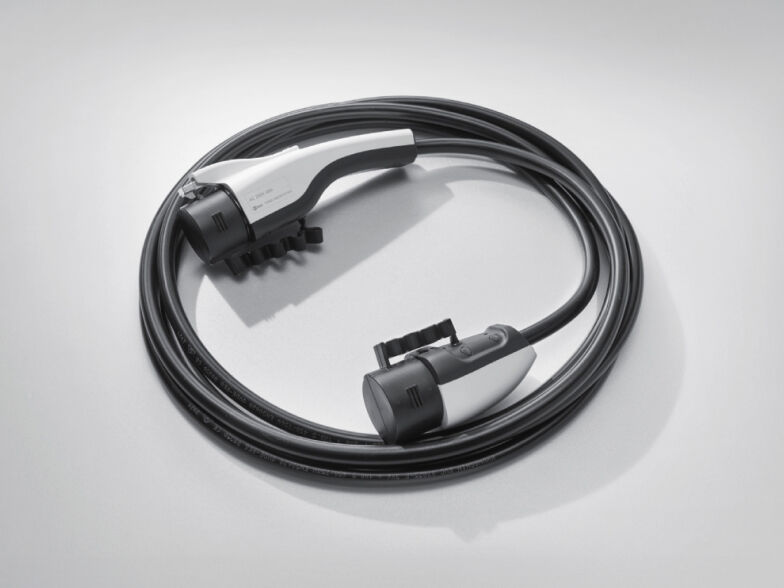 The cable for charging an electric car is coiled in rounds.