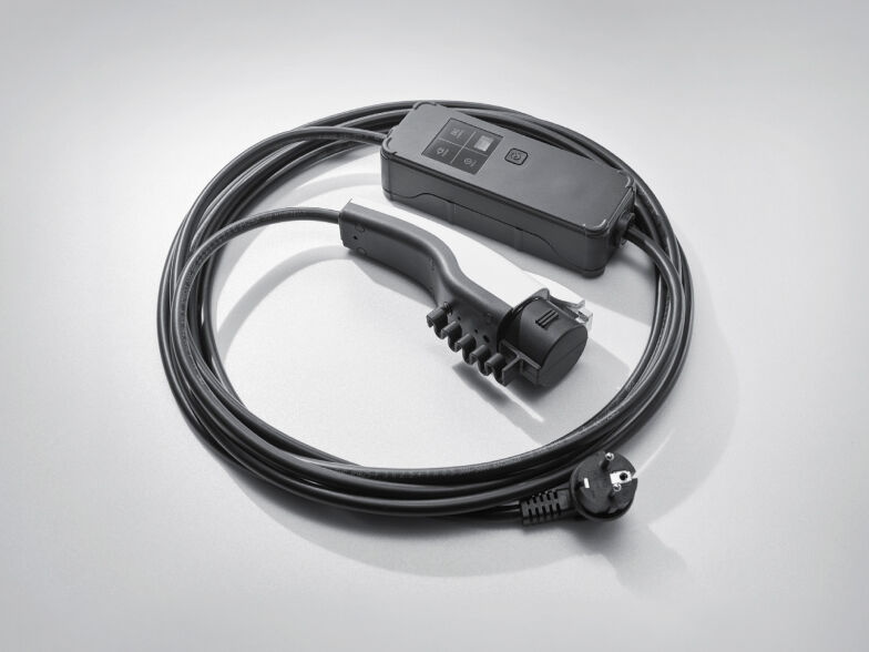 The cable for charging an electric car is coiled in rounds.