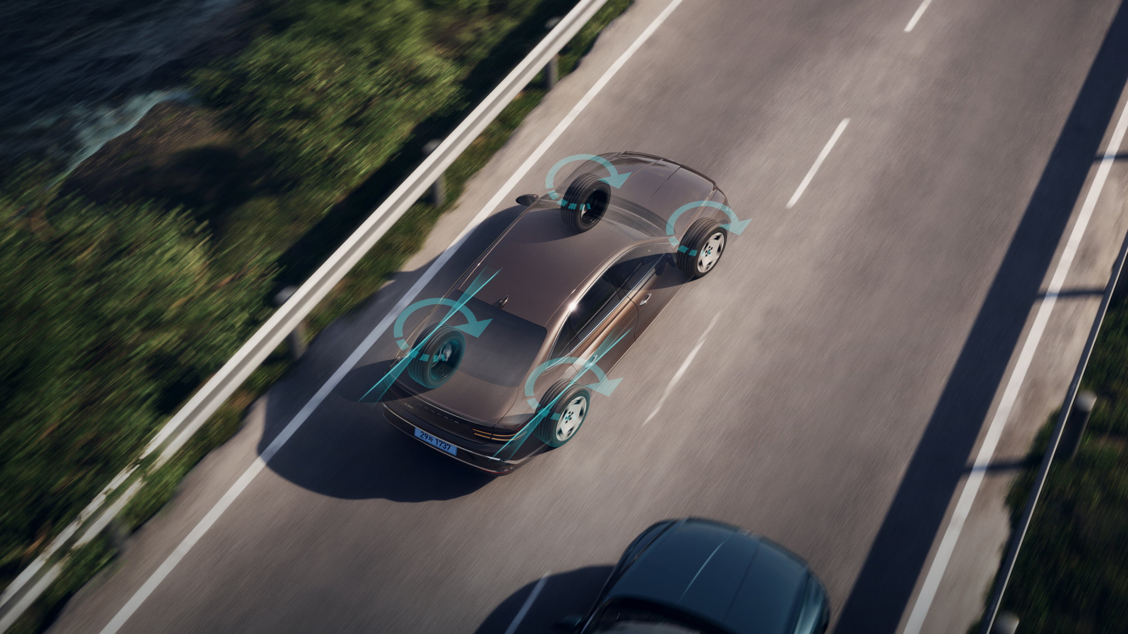 An aerial view of an Electrified G80 driving on a straight road. The direction in which the four wheels are moving with RWS(Active Rear Wheel Steer) is shown.
