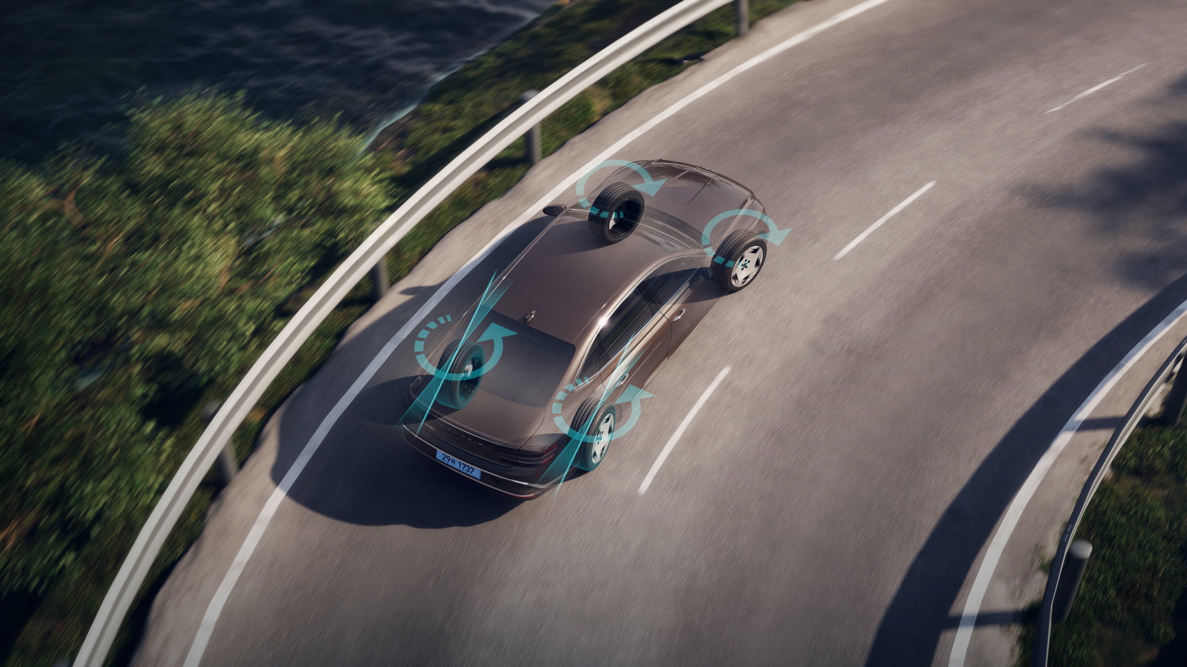 An aerial view of an Electrified G80 driving on a curvy road. The direction in which the four wheels are moving with RWS(Active Rear Wheel Steer) is shown.
