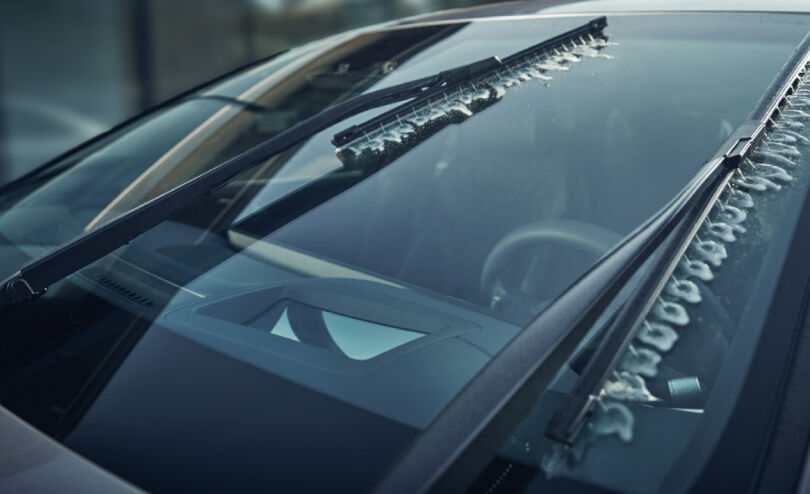 The wiper cleans the glass as the washer fluid is sprayed onto the windshield.