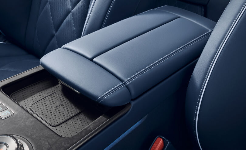 You can see the console armrest in the front seat. It has an NFC space for charging your smartphone.