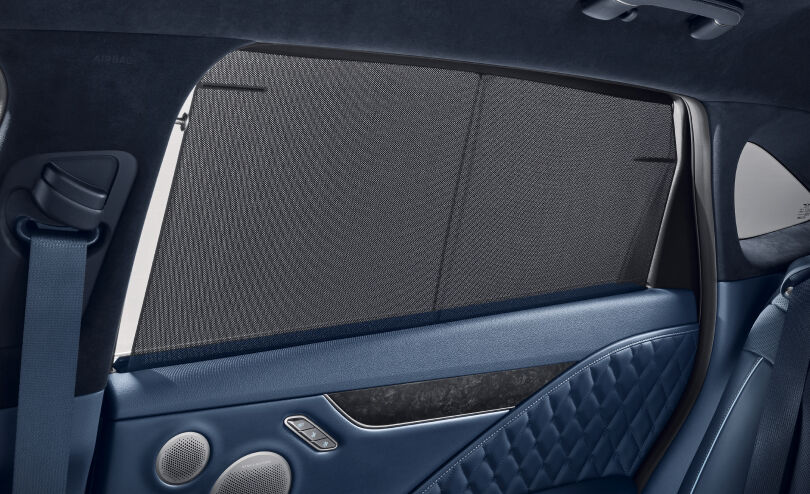 The motorized door curtain on the rear window is visible. 