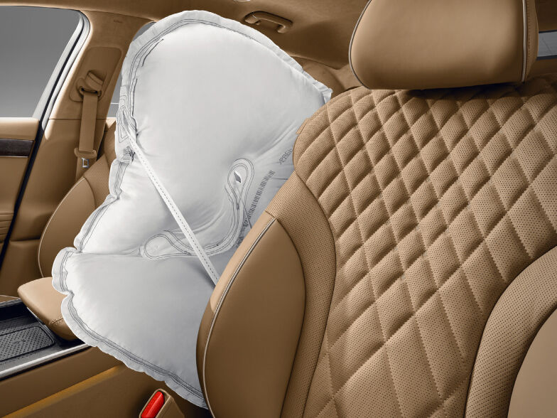 An inflated airbag is visible between the driver and passenger seats