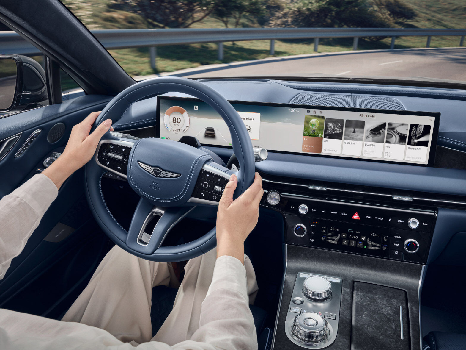 A partial view of you sitting in the driver's seat and operating the steering wheel.