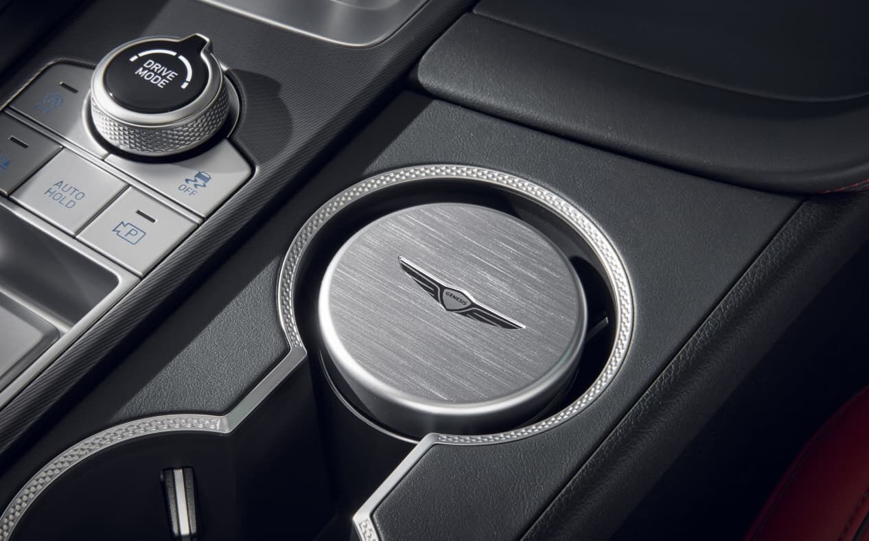 The metal ash tray with the Genesis logo engraved on it.