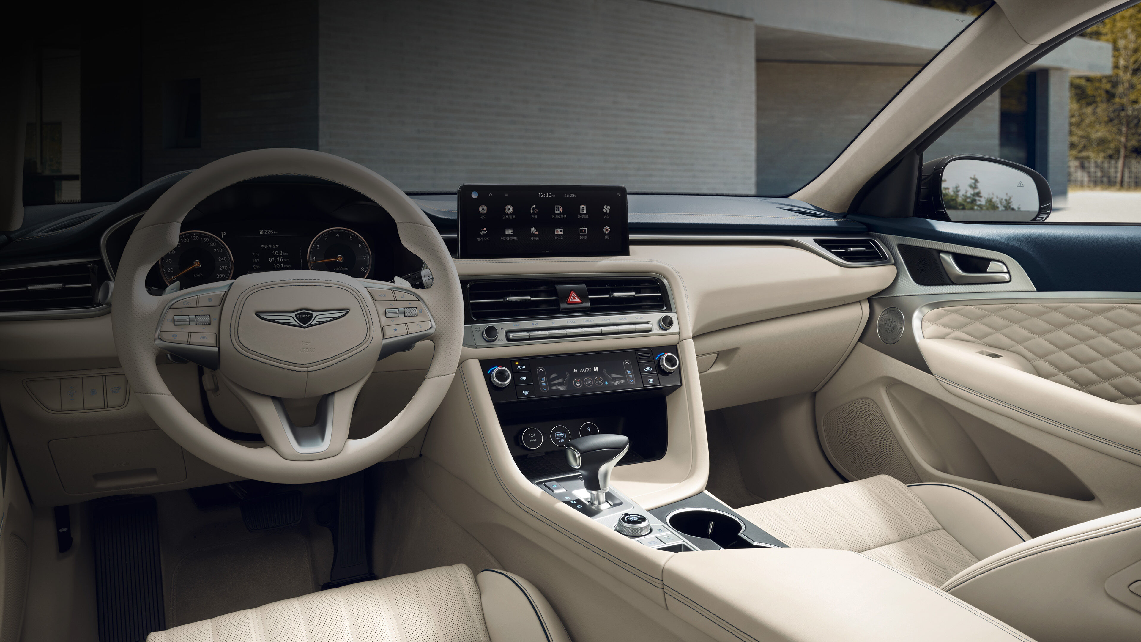 The interior of the G70 Shooting Brake, including the infotainment system, cluster, and air conditioning panel.