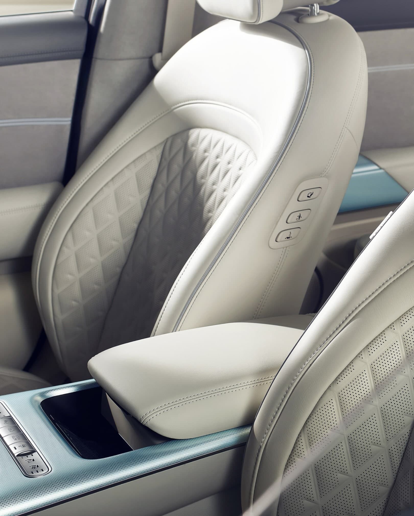Driver's seat, passenger seat, and console armrest inside GV60.